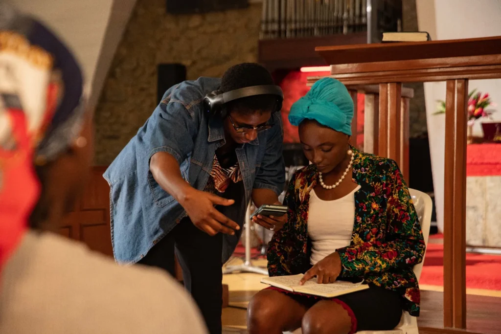 Orobosa Ikponmwen directing actors on the set of Adanne