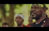 Sam Dede wearing a camouflage headband outdoors in Issakaba Returns