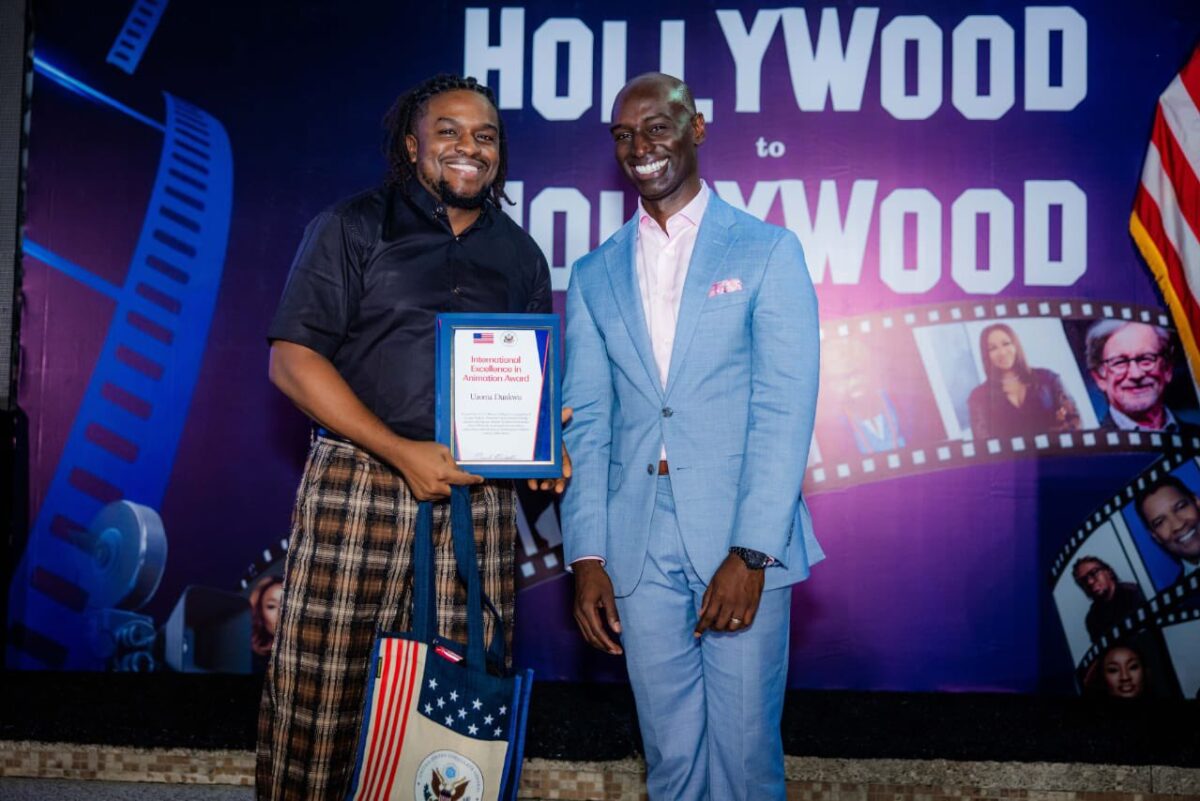 Uzoma Dunkwu holding the International Excellence in Animation Award presented by the U.S. Mission in Nigeria.