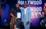 Uzoma Dunkwu holding the International Excellence in Animation Award presented by the U.S. Mission in Nigeria.