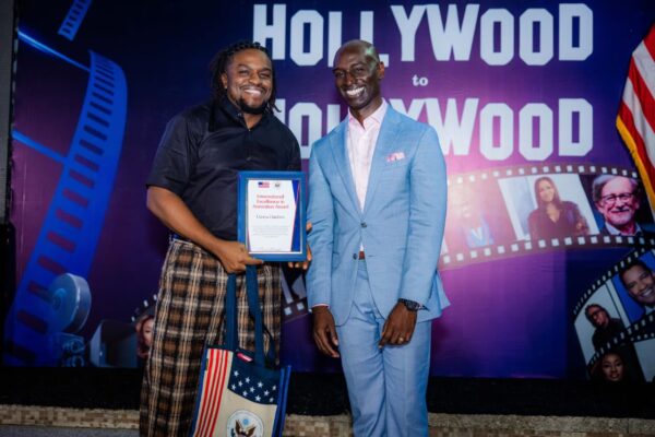 Uzoma Dunkwu holding the International Excellence in Animation Award presented by the U.S. Mission in Nigeria.